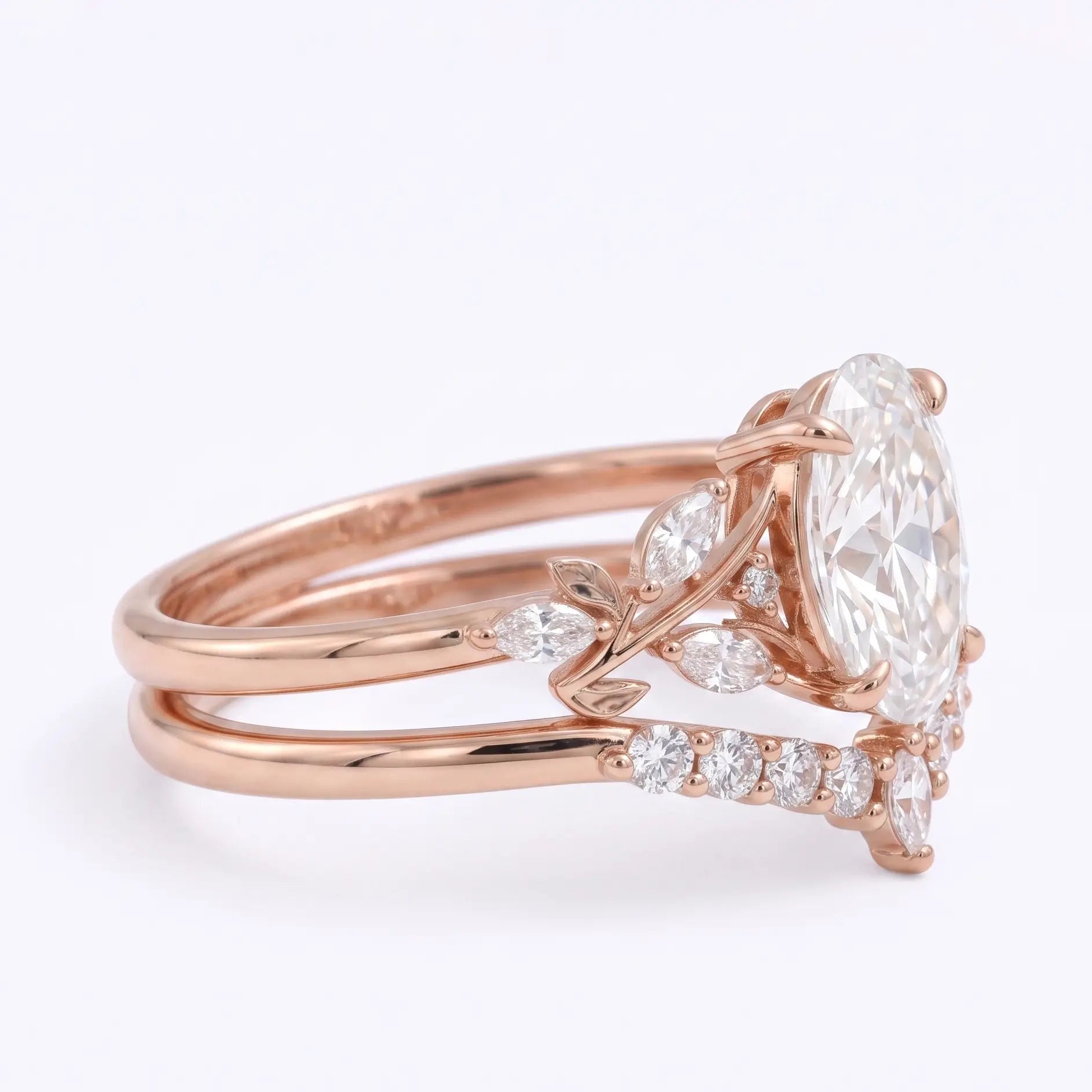 Rose gold moissanite bridal set with oval center stone and curved nesting band