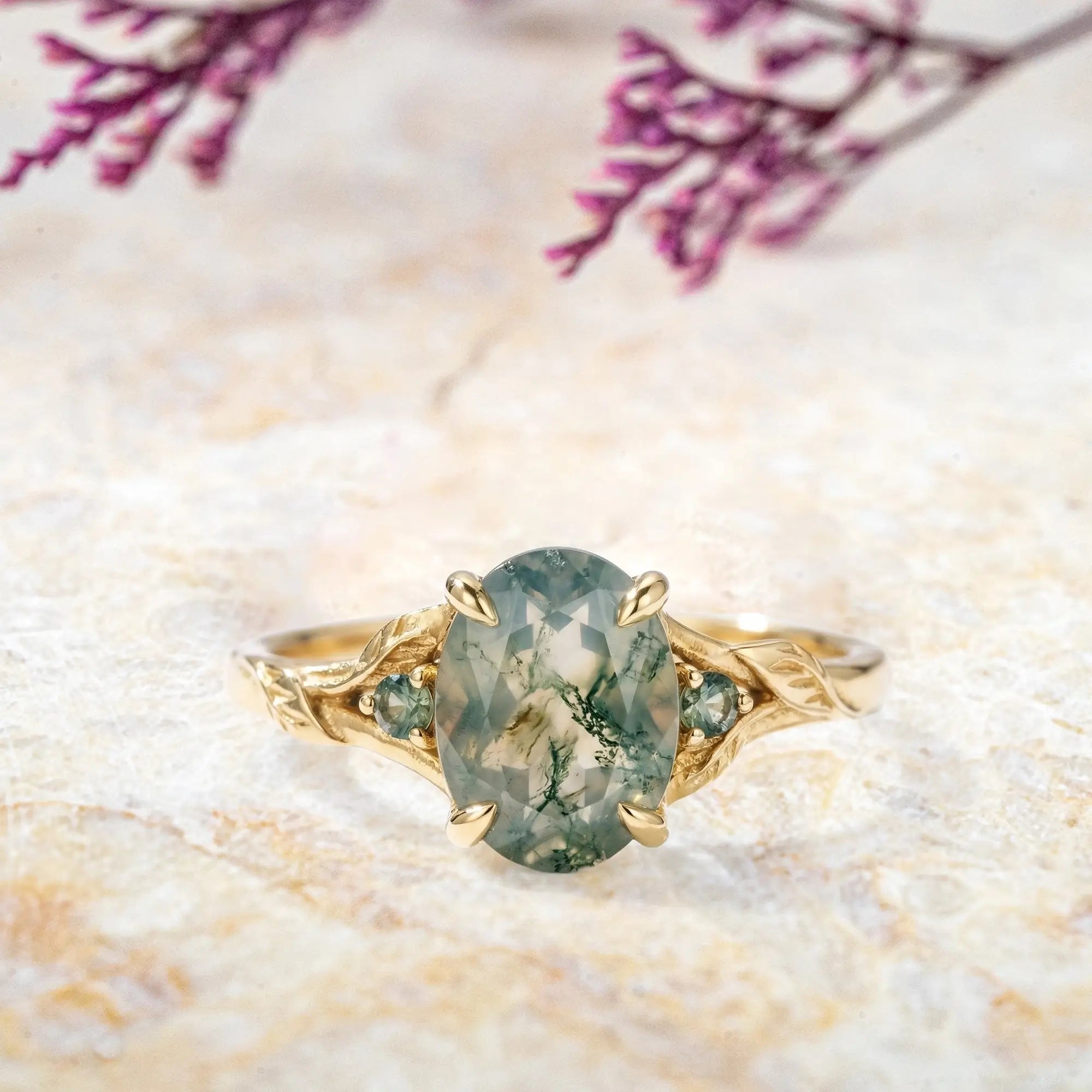 Oval moss agate engagement ring with nature inspired leaf band three stone rings