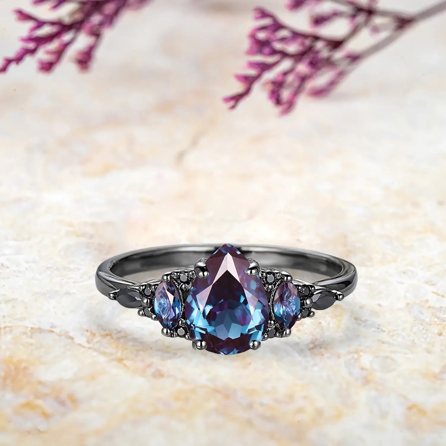 Pear alexandrite engagement ring with black moissanite marquise cluster and chevron wedding band in black gold