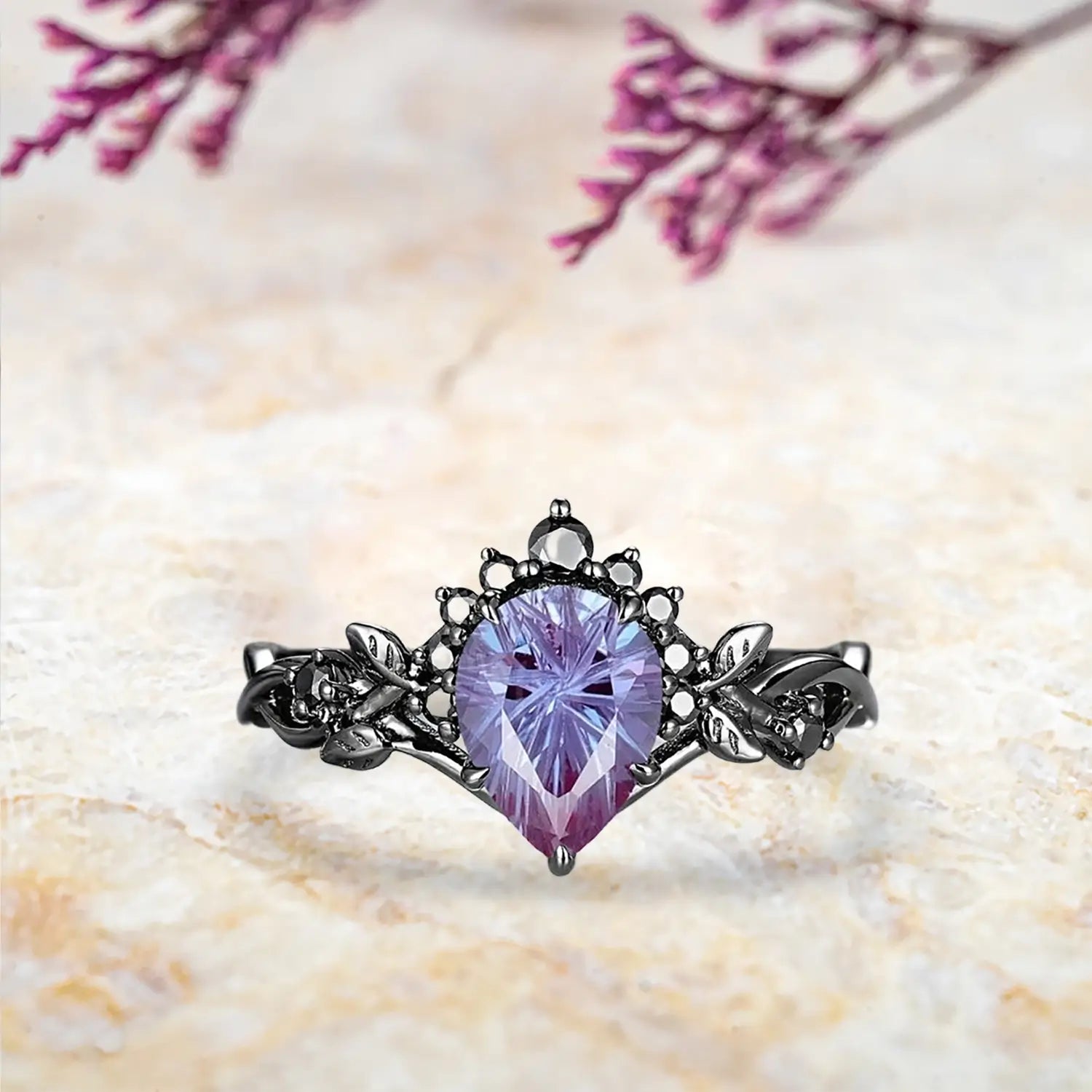 Pear alexandrite fireworks engagement ring with Gothic half halo crown and curved leaf wedding band in black gold