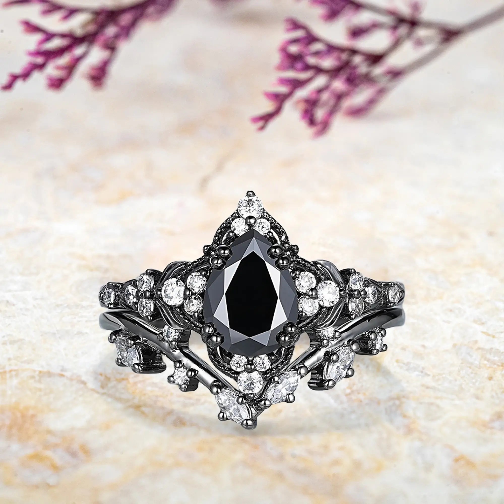 Pear black onyx engagement ring with leaf crown milgrain halo and chevron diamond wedding band set in black gold