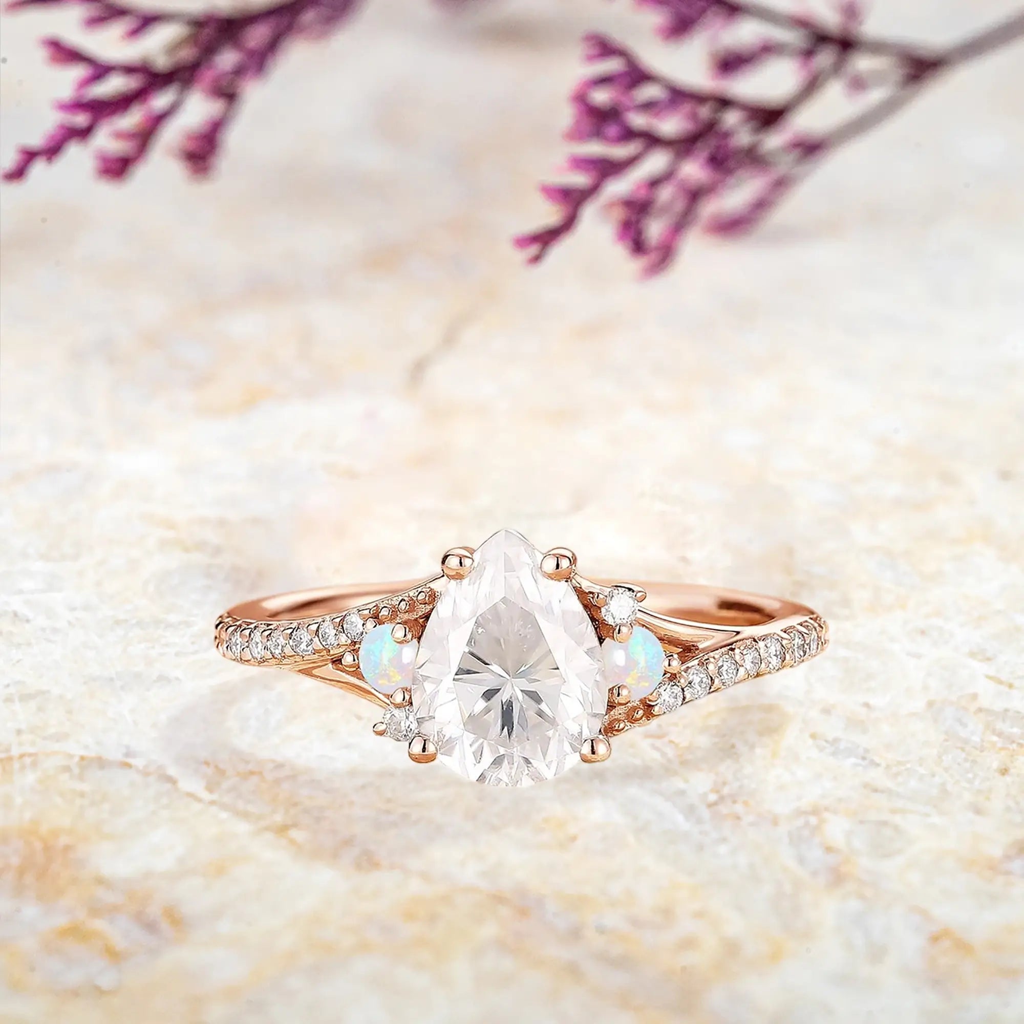 Pear cut moissanite engagement ring with opal accents in rose gold Art Deco design