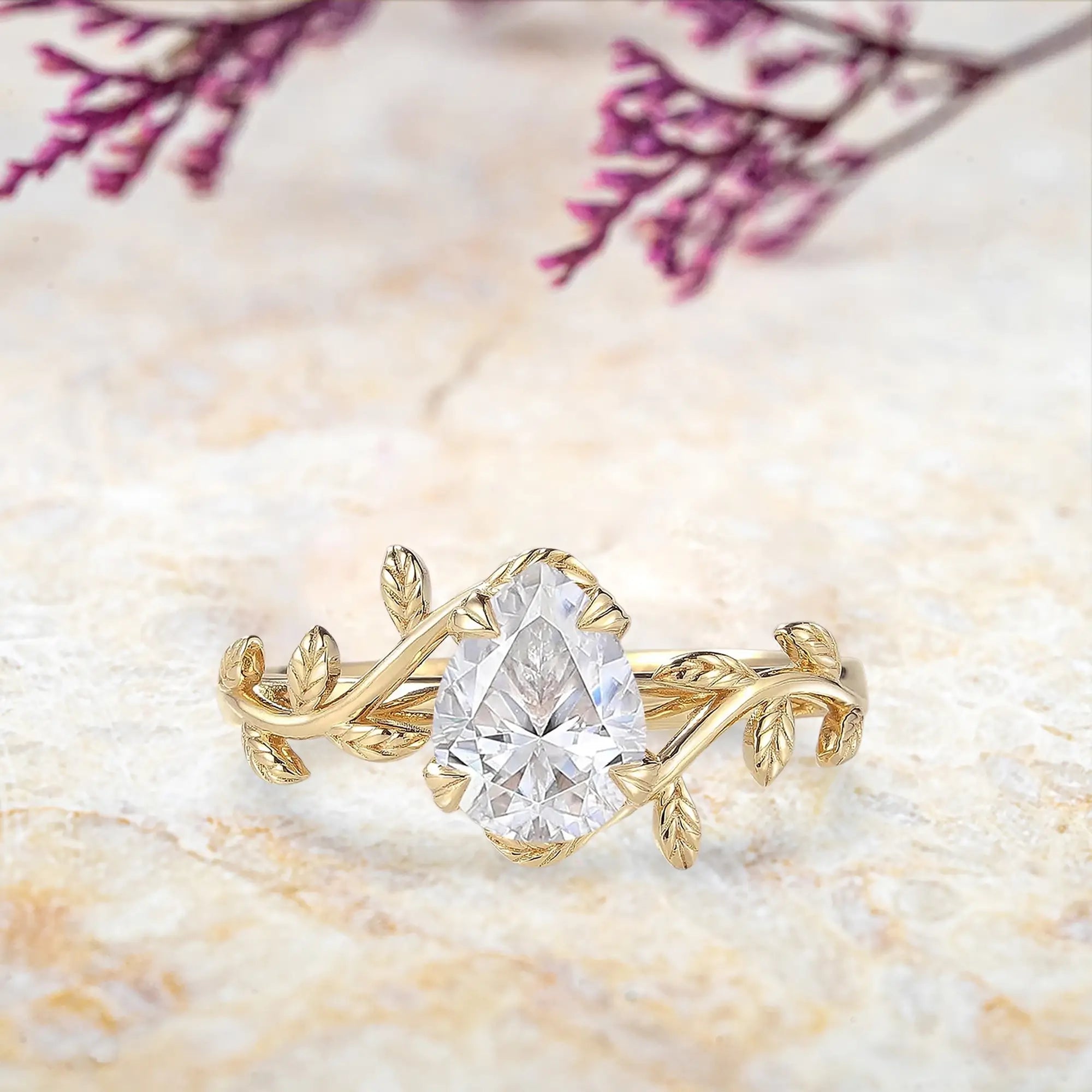 Pear moissanite engagement ring in yellow gold with leaf branch design nature inspired