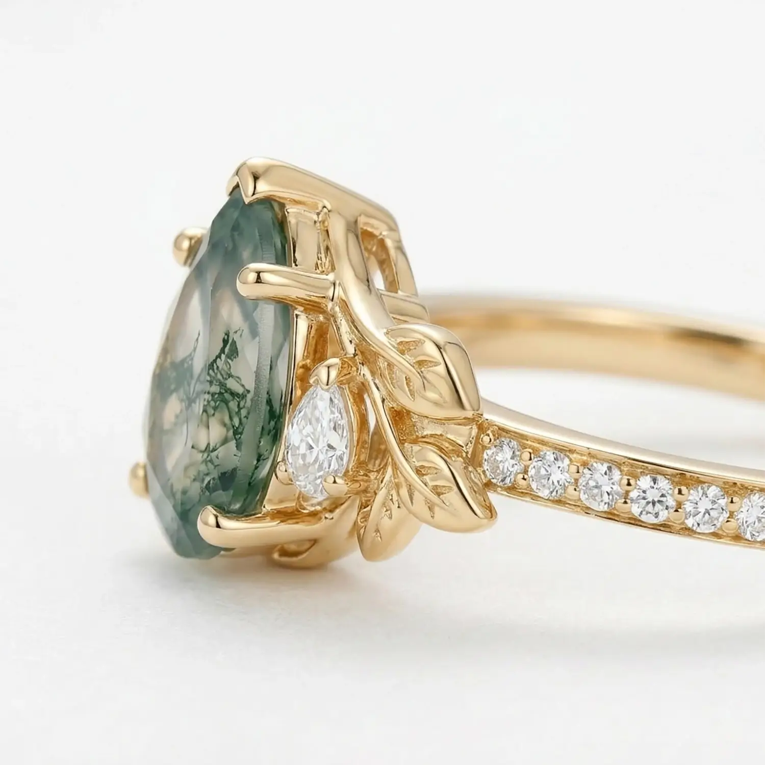 natural pear moss agate engagement ring with leaf design and moissanite stones close up detail
