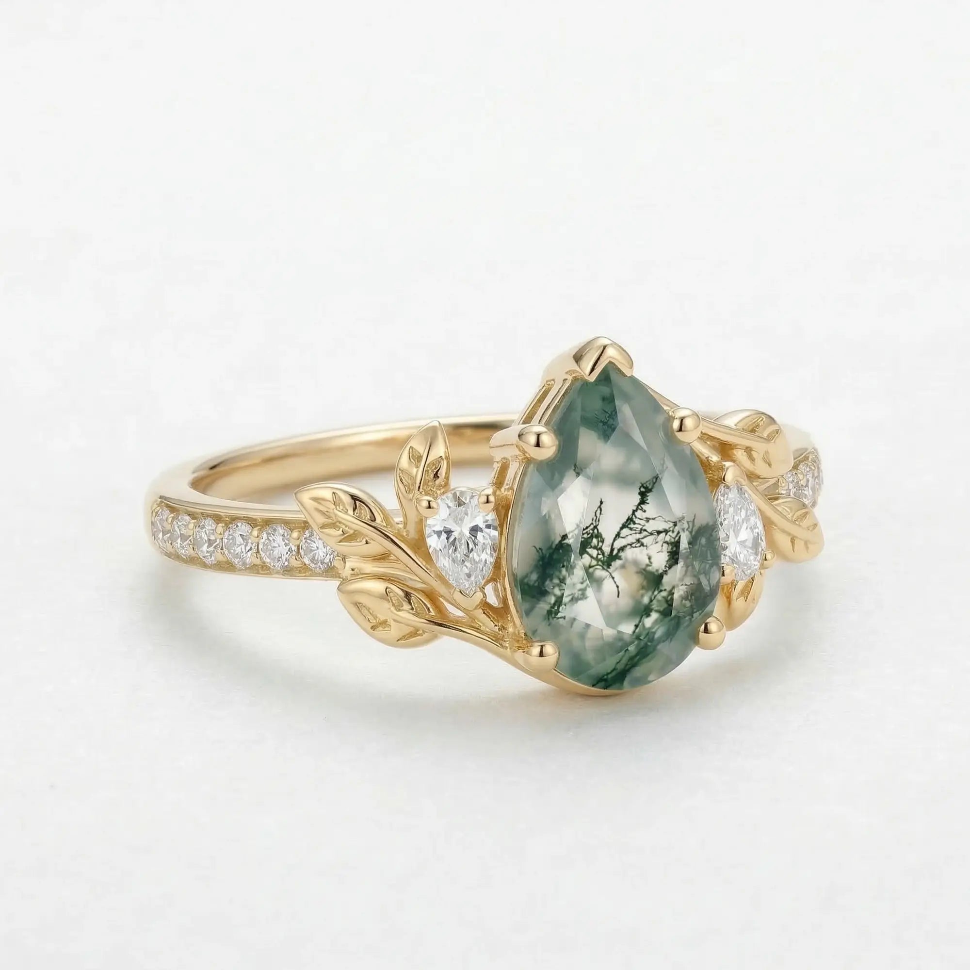 natural pear moss agate engagement ring with leaf design and moissanite stones close up detail