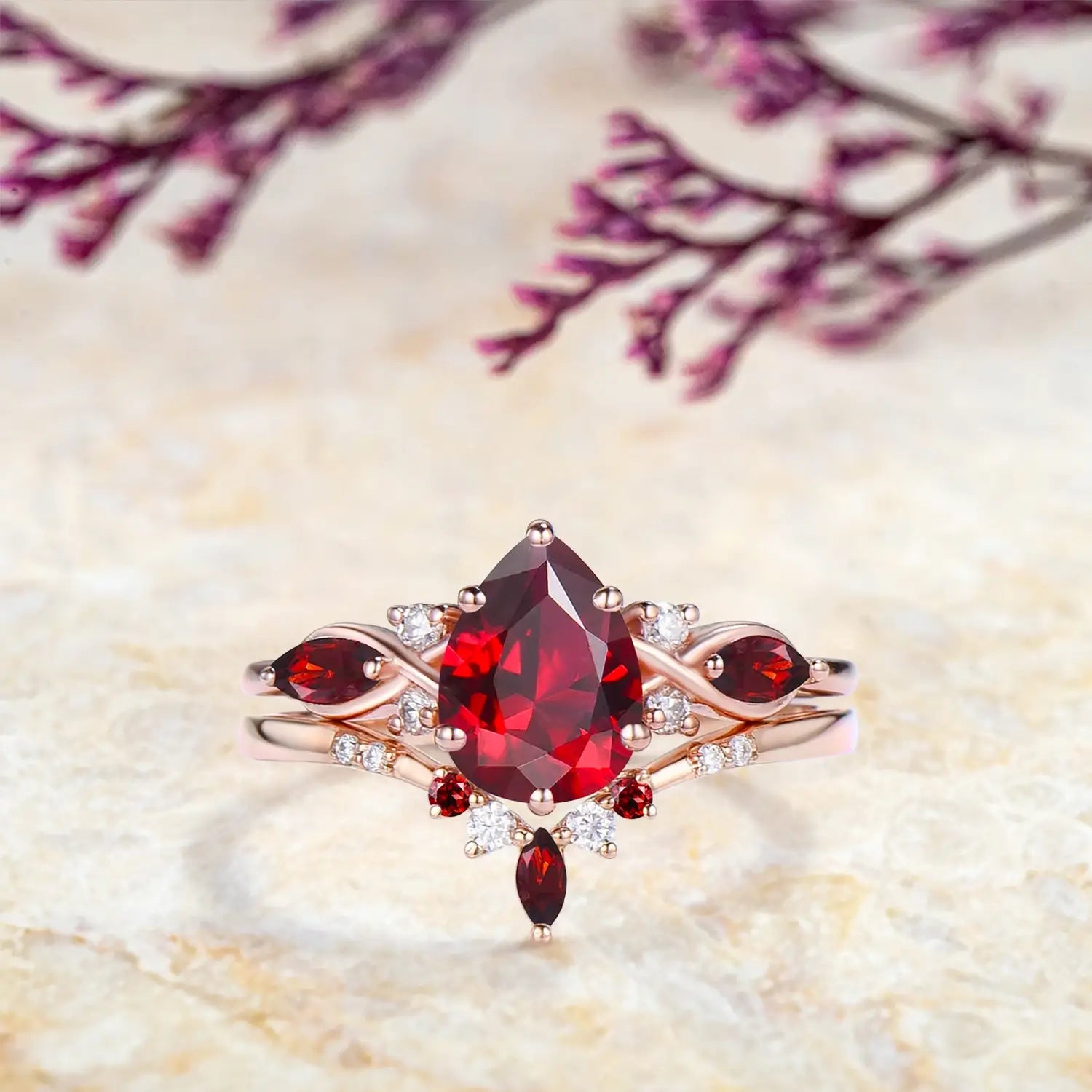 Pear ruby engagement ring with marquise ruby cluster and diamond accents with V shaped wedding band set