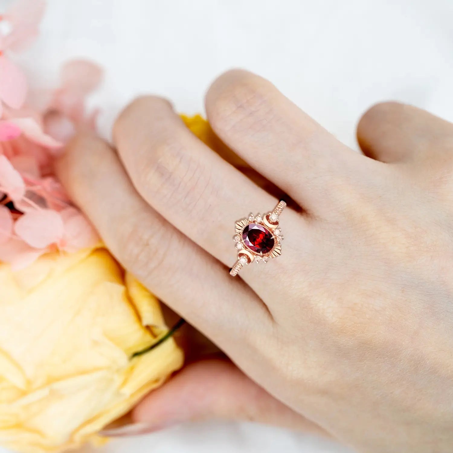 Handmade gold garnet wedding ring with moissanite halo