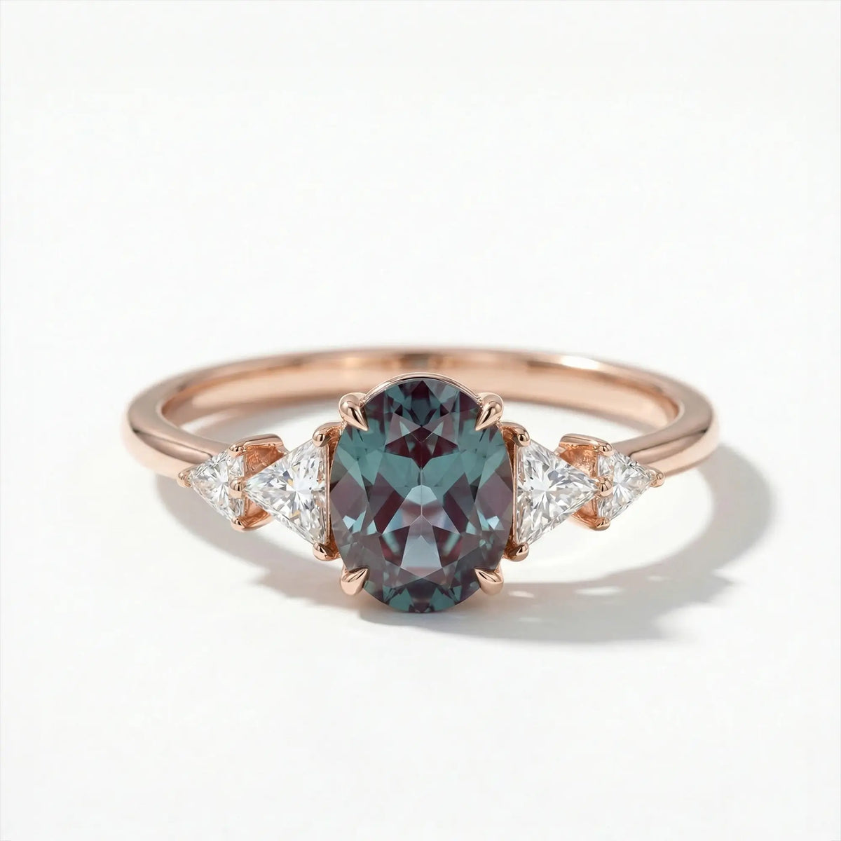 Modern oval cut alexandrite five stone engagement ring with trillion moissanite accents
