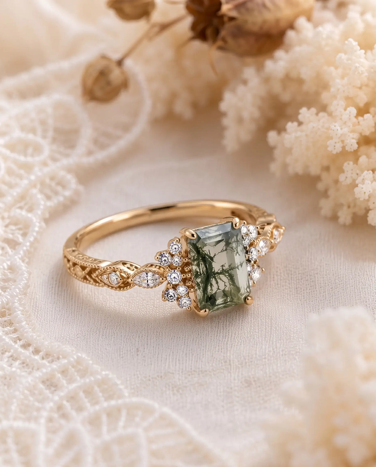 Lifestyle jewelry image of Verdelisse, a vintage emerald cut moss agate cluster ring with romantic gold details and luxurious sparkle.